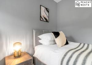 a bedroom with a bed with a lamp on a night stand at Contractor Pad with off-Road Parking Sleeps 5 in Norwich