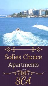 a boat in the water with a sign that reads societies choice apartments at SOFIES CHOICE Suite in Chalkida