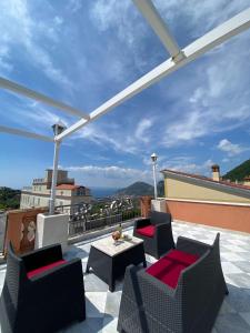 a patio with chairs and a table on a roof at Le Due Sirene in Piano di Sorrento