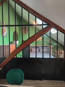 アランソンにあるGîte des grangesの緑の壁と緑の椅子が備わるお部屋