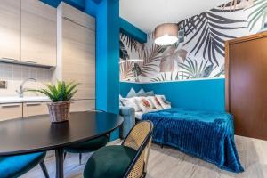 a living room with a table and a couch at Belmeloro Home in Bologna