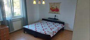 a bedroom with a bed with a floral bedspread at Nika in Rijeka
