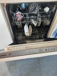 a dishwasher with a rack full of dishes at Dolce Relax - Calabria in Catanzaro