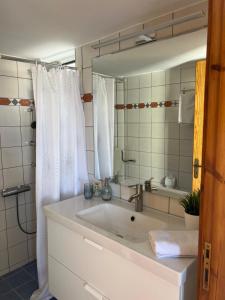 a white bathroom with a sink and a mirror at Ninemia Apartment in Kaloi Limenes