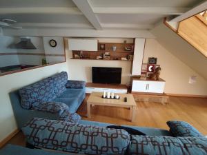 a living room with two blue couches and a table at Apartamento Premium Relax C in Bárcena de Cicero