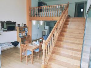 a wooden staircase with a table and a desk at Apartamento Premium Relax C in Bárcena de Cicero