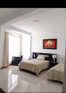 Een bed of bedden in een kamer bij D'eluxe Hotel Talara ubicado a 5 minutos del aeropuerto y a 8 minutos del Centro Civico