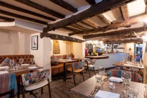 a restaurant with tables and chairs and a bar at Wisteria Hotel in Oakham