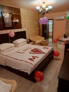 a bedroom with a bed with red and pink decorations at Al-Naher Al-Khaled Hotel in Aqaba