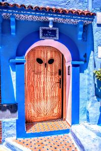 a wooden door with an owl design on it at Old world charm, modern comfort in Chefchaouen
