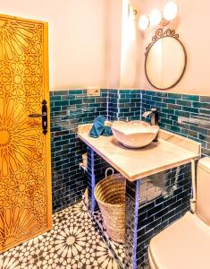 a bathroom with a sink and a mirror at Old world charm, modern comfort in Chefchaouene