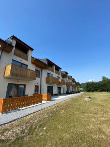 a row of houses with balconies and a yard at Kasperky 14 in Kašperské Hory