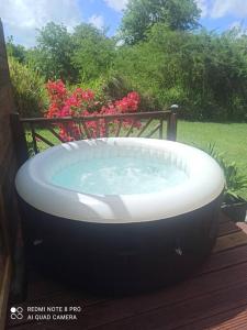 a large bath tub sitting on a deck at Horizons Caraïbes in Sainte-Luce