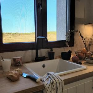 a kitchen counter with a sink and a window at CASAGUAPA Alto Tajo in Armallones