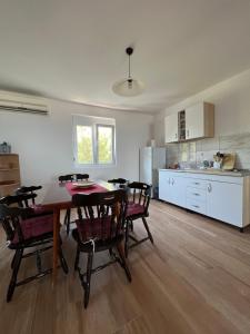 a kitchen and dining room with a table and chairs at Apartments Andrović in Ulcinj