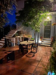 a table and chairs on a patio at night at Quinta do Eco in Vila de Rei