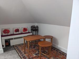 a table and two stools in a room at House of Bondol in Aberdeen +16 photos