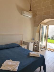 Ένα ή περισσότερα κρεβάτια σε δωμάτιο στο Masseria Strada Agriturismo