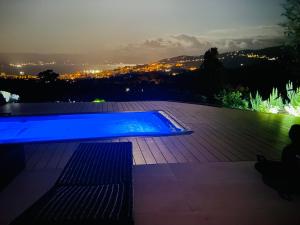 a swimming pool at night with a view of a city at CASA LC chambre3 vue mer SPA de NAGE in Ajaccio