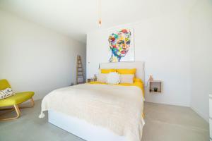 a bedroom with a bed with a colorful headboard at CHAMBRE DELUXE 3 vue mer SPA de NAGE in Ajaccio