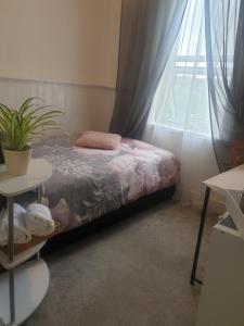 a bedroom with a bed and a window at Sweet Dreams in Luton