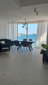 a living room with a couch and a table with chairs at Apartment Nino in Zadar