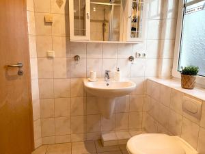a bathroom with a sink and a toilet at Haus Eversand Nr 1 in Cuxhaven +9 photos