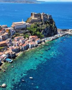 an aerial view of a town on a island in the ocean at B&B La Bastia in Scilla