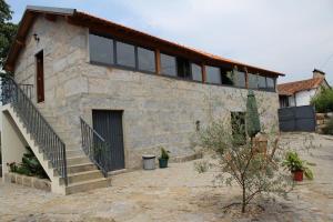 a stone house with a staircase in front of it at Casa do Villas in Castelo de Paiva