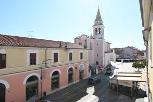 a city street with a church with a clock tower at Apartment Summer Cave in Poreč center in Poreč