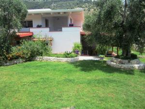 a house with a lawn in front of it at B&B Tor Di Lupo in Mattinata