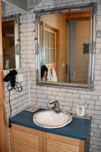 a bathroom with a sink and a mirror at Charzykowska Chatka in Charzykowy