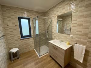 a bathroom with a sink and a shower at Apartamentos 4 estações in Faja Grande +60 photos