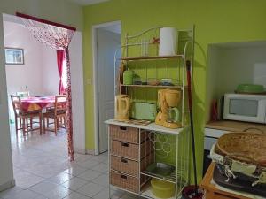 a kitchen with a shelf with appliances on it at Gite Sud de France-Carcassonne chez Léa in Aragon