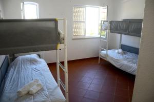 a room with two bunk beds and a tiled floor at Villa 46 Hostel in Lagos