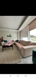 a living room with a couch and a table at Arcadia homes avsallar in Alanya