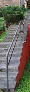 a set of concrete stairs with a metal hand rail at a dos pasos de san Mamés in Bilbao