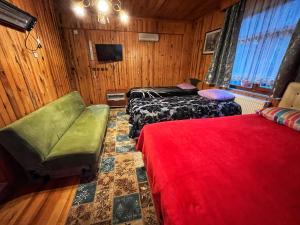 a room with two beds and a chair and a television at Zirve Apart in Uzungöl