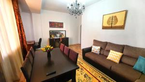 a living room with a couch and a table at Stylish apartment in the city center in Bishkek