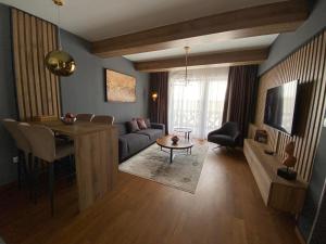 a living room with a couch and a table at Nivalis Residence Jahorina in Jahorina