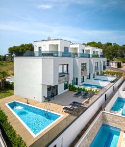 eine Luftansicht eines Hauses mit zwei Swimmingpools in der Unterkunft Villas Residence 360 in Trogir