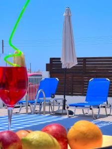 a table with fruit and a drink and an umbrella at 3 Bedroom Coral Bay Beach Seaview Villa II Private Pool in Coral Bay