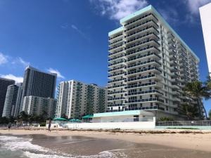 a tall building next to a beach with buildings at Penthouse Beach Front 1st line, 2 BR, 2 BA, New Decoration & Furnitures, unobstructed view of the beautiful Atlantic, free parking in Hollywood