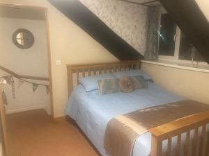 a bedroom with a bed in a attic at Main Street 2 bedroom town house in Llandeilo