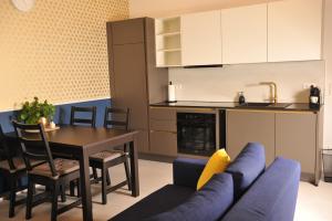 a kitchen and dining room with a blue couch and a table at Beim Bergjosl in Kirchbach in Steiermark