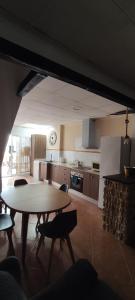 a kitchen with a table and chairs in a room at CaPepica in Ráfol de Salem