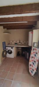a small kitchen with a stove and a microwave at CaPepica in Ráfol de Salem