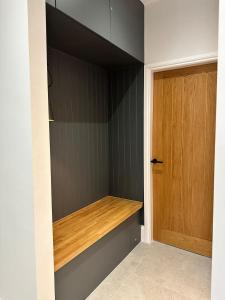 a closet with a wooden shelf next to a door at Glasgow West End Tenement Apartment in Glasgow