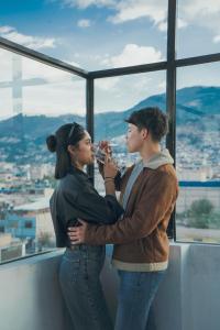 two people standing in front of a window drinking wine at Marzano in Cajamarca