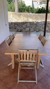 un tavolo in legno con 2 sedie e una panca di legno di Casa Vacanza a Palermo